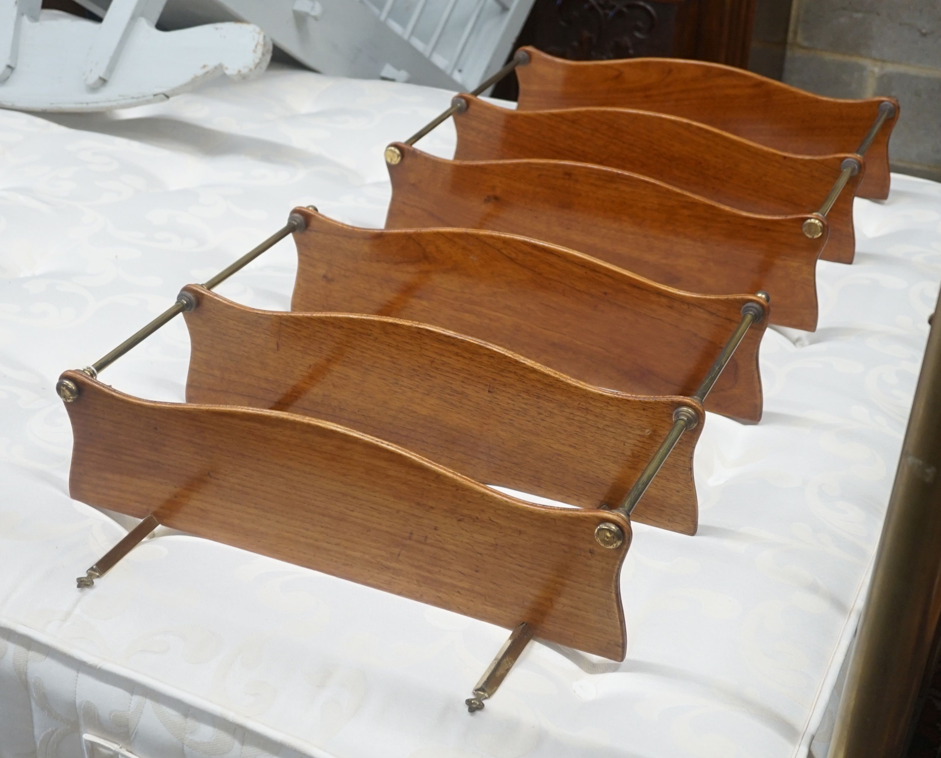 A pair of brass mounted serpentine mahogany three tier wall brackets, width 60cm depth 17cm height 70cm